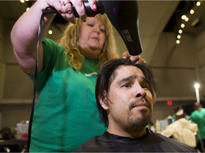 Patrick Kashmir Whiskeyjack has his hair cut by Cindy Gage at the Homeless Connect event in Edmonton on May 15, 2016.