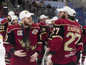 West Kelowna Warriors forward Connor Sodergren, left, and teammate Kyle Marino celebrate after receiving their gold medals at the 2016 Royal Bank Cup in Lloydminster on May 22, 2016. The Warriors defeated the Lloydminster Bobcats 4-0 Sunday to claim their first ever national junior A hockey championship.