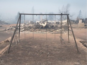 A burned swing set sits in a residential neighbourhood destroyed by a wildfire on May 6, 2016 in Fort McMurray.