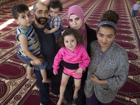 Fort McMurray wildfire evacuees Mohamed Artima, his wife Dunia Abuwatfa, and his children Hanan Artima, 13, Abbas Artima, 4, Miriam Artima, 2, and Eissa Artima, 1, pose for a photo at the Al Rashid Mosque, 13070 - 113 St., on Wednesday May 4, 2016.