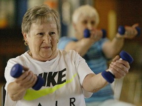 Two seniors participate in the women-on-weights program for women 65 and over at a seniors centre in Windsor, Ont.