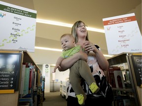 Minister of Service Alberta Stephanie McLean holds her four month-old son Patrick McLean - Bostock, as she announces the top boy and girl baby names in Alberta for 2015, at the Mill Woods Library branch.