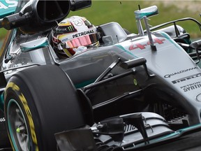 Mercedes AMG Petronas F1 Team's British driver Lewis Hamilton powers through a corner during the first practice session for the Formula One Australian Grand Prix in Melbourne on March 18, 2016. / AFP PHOTO / Paul Crock / --IMAGE RESTRICTED TO EDITORIAL USE - STRICTLY NO COMMERCIAL USE--PAUL CROCK/AFP/Getty Images