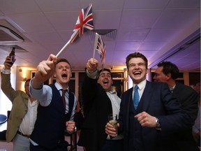 Leave.EU supporters wave Union Jack flags and cheer as results come in from Britain's referendum, which sent the pound plummeting.