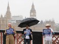 Campaigners hold placards for 'Britain Stronger in Europe', the official 'Remain' campaign group seeking to avoid a Brexit, ahead of the forthcoming EU referendum, in London on June 20, 2016.