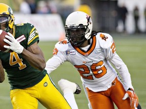 B.C. Lions Cord Parks (26) chases as Edmonton Eskimos Adarius Bowman (4) makes the catch during first half CFL action in Edmonton, Alta., on Saturday November 1, 2014.