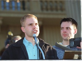 Delwin Vriend, left, speaks at the Alberta Legislature in 1998 after the Supreme Court rules in his favour.