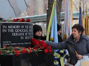 Dr. Elaine Harasymiw lays a rose at the Holodomor monument in memory of those who perished in the genocidal famine in the 1930s in this file photo.