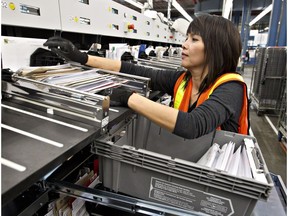 A worker sorts letters at the Edmonton Canada Post plant.