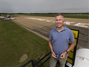 Jim Johannsson on a Second World War-era slip for removing seaplanes from the water at Cooking Lake Airport, which now rests in mud.