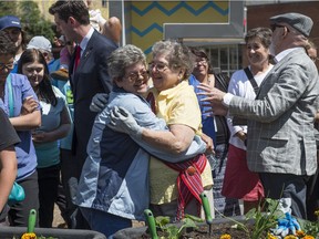 Two great nieces of Alex Decoteau embrace Friday at the groundbreaking of a downtown park in his name. Shirley Marshall, left, and Izola Mottershead joined Mayor Don Iveson  and others at the ceremony.