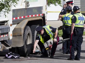 Police investigate after a 11-year-old girl was struck by a garbage truck near Velma Baker School on Wednesday, June 15, 2016.
