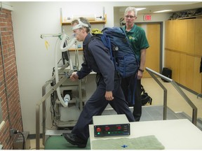 Dr. Stewart Petersen is currently researching the effects of different work clothing on performance and physical employment standards in a lab at the University of Alberta. Mike Scarlett wears overalls and a backpack to test firefighters clothing.