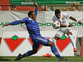 FC Edmonton Eddie Edward (left) and Fort Lauderdale Strikers Walter Ramirez (right) chase down the ball during North American Soccer League game action in Edmonton on August 23, 2015. Edward left FC Edmonton for family reason and signed with his hometown team the Ottawa Fury.