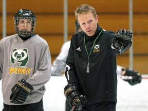 EDMONTON, ALBERTA: JANUARY 28, 2015 - University of Alberta Pandas' head coach Howie Draper (right) gives instruction during team practice at Clare Drake Arena on January 28, 2014. Story by Richard Cantangay-Liew. (PHOTO BY LARRY WONG/EDMONTON JOURNAL)