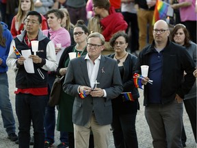 Hundreds of people attended a candlelight vigil on the front steps of the Alberta Legislature in Edmonton on June 12, 2016 in memory of the shooting victims in Orlando, Florida.