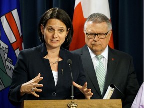 Alberta Municipal Affairs Minister Danielle Larivee and Public Safety Minister Ralph Goodale discuss the wildfire recovery plans for Fort McMurray at a meeting held at the Alberta legislature in Edmonton on June 17, 2016.