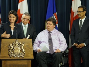 Alberta Municipal Affairs Minister Danielle Larivee (from left); federal Public Safety Minister Ralph Goodale; Veterans Affairs Minister Kent Hehr, chair of the ad hoc committee on northern Alberta wildfires; and Infrastructure Minister Amarjeet Sohi, announce cash for Fort McMurray wildfire relief Friday at the legislature.