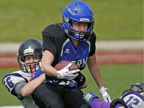 Edmonton Storm #22 is tackled by Lethbridge Steel's Megan Podrasky (left) and Alex Babiarz-Graveline (right) during Western Women's Canadian Football League West Division final playoff game action at Jasper Place Bowl in Edmonton on June 18, 2016.