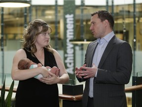 Alberta Economic Development Minister Deron Bilous speaks with TEC Edmonton client Elisse Moreno, founder of HomeTribe. 
She is holding her five-day-old baby Harrison at Enterprise Square.