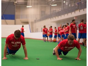 Jayden Platz, left, and Ethan Cap do pushups during the Edmonton Oil Kings rookie fitness testing session in August 2015.
