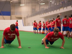 EDMONTON, ALTA: AUGUST 27, 2015 Jayden Platz and Ethan Cap do pushups during the Edmonton Oil King's rookie fitness testing session at the Dow Centennial Centre in Fort Saskatchewan on August 27, 2015.(Photo by Brady McDonald / Edmonton Journal)