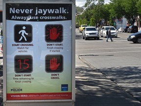 Anti-jaywalking sign recently installed on Whyte Avenue near 101 Street, a location where two people have been killed while crossing the road legally.