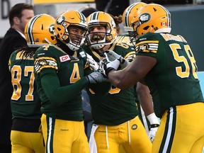 EDMONTON, ALTA: NOVEMBER 22, 2015 -- Edmonton Eskimos Adarius Bowman (4) celebrates with Tony Washington (58) after he scored a TD against the Calgary Stampeders during the CFL Western Final at Commonwealth Stadium in Edmonton, November 22, 2015. (ED KAISER/EDMONTON JOURNAL)