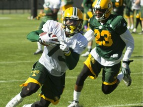 Edmonton Eskimos Anthony Barrett (73) turns upfield with the ball while being pursued by defensive back Marcell Young (23) during training camp at Commonwealth Stadium in Edmonton Alta. on Tuesday May 31, 2016. Robert Murray/Fort McMurray Today/Postmedia Network