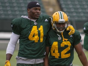 Edmonton Eskimos defensive end Odell Willis, left, and defensive back Tyler Thornton share a moment while walking off the field during practice at Commonwealth Stadium in Edmonton Alta. on Wednesday June 8, 2016.