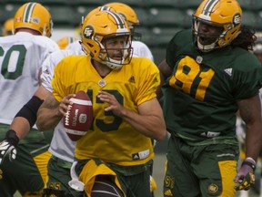 Edmonton Eskimos quarterback Mike Reilly scrambles from the pocket to make a pass during practice at Commonwealth Stadium in Edmonton on June 8, 2016.