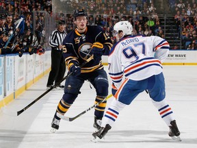 BUFFALO, NY - MARCH 01: Jack Eichel #15 of the Buffalo Sabres passes the puck against Connor McDavid #97 of the Edmonton Oilers at First Niagara Center on March 1, 2016 in Buffalo, New York.