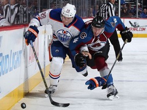 DENVER, CO - DECEMBER 19:  Lauri Korpikoski #28 of the Edmonton Oilers and Tyson Barrie #4 of the Colorado Avalanche pursue the puck at Pepsi Center on December 19, 2015 in Denver, Colorado.
