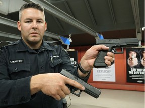 Const. Clay Hilbert holds two handguns, one real, the other a fake. EPS launched a safety campaign in Edmonton on Wednesday, June 29, 2016, to educate youth on the dangers of playing with imitation guns in public spaces.