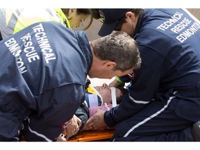 Edmonton Fire Department Technical Rescue members demonstrate a rescue during First Responders Day in Churchill Square, in Edmonton Alta. on Thursday June 9, 2016. Organizers say the event was an opportunity for the public to meet first responder members outside of an emergency situation. Photo by David Bloom