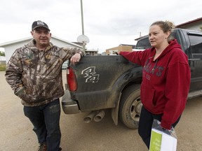 Residents Lee and Anji  Wood returned to their home in Anzac, Alta., on Wednesday June 1, 2016 with supplies including water.