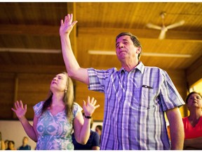 Members of Fort City Church sing during their re-entry worship service on June 5, 2016, in Fort McMurray. This is the first service in the church since residents were forced to evacuate the city on May 3 due to wildfires.
