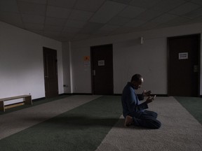 Mohamud Alihashi prays at the Markaz Ul Islam mosque after returning to Fort McMurray on June 1, 2016.