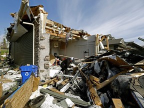 Fort McMurray resident Jim Wood surveys the remnants of his fire-ravaged home in Fort McMurray on Thursday, June 2, 2016. The authorities are urging returning Fort McMurray residents not to pick through debris.