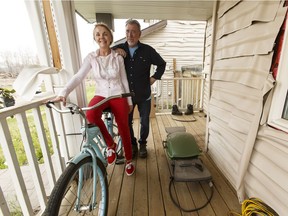 Veronica Wakeham (left) and Robert Hodder pose with her bicycle on their deck in the Abasand neighbourhood of Fort McMurray, Alta., on Wednesday June 8, 2016.