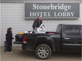 Shelly and Kevin Hinds pack up their belongings outside the Stonebridge Hotel, in Fort McMurray Alta. on Wednesday June 15, 2016.