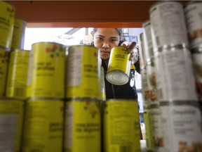 A volunteer stocks shelves at the Wood Buffalo Food Bank, in Fort McMurray Alta. on Friday June 17, 2016.