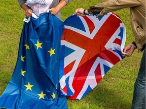 Two people hold an European Union and United Kingdom at the castle of Hardelot, the cultural center of the Entente Cordiale (the colonial-era promise of cross-channel friendship between Britain and France).  Britain has voted to break out of the European Union, striking a thunderous blow against the bloc and spreading panic through world markets on June 24, 2016 as sterling collapsed to a 31-year low.