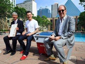 Director of city environmental strategies Mark Brostrom (left), Edmonton Oilers defenceman Andrew Ference and city councillor Ben Henderson size up the new Soofa bench (named Winston) in Sir Winston Churchill Square on Tuesday.