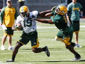 Greg Morris, left, is tackled by C.J. Morgan during Edmonton Eskimos training camp at Commonwealth Stadium in Edmonton, Alta., on Monday, June 13, 2016. (Codie McLachlan/Postmedia)