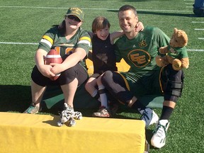 Dana and Cameron Nagel with Edmonton Eskimos quarterback Mike Reilly.