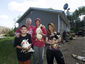 The Manshanden family, Nathan, 11, Derek, Justin, 13, and Marie on June 4, 2016. They returned to their acreage outside of Fort McMurray to find some ducks left behind when they fled the wildfire had been taken care of by a neighbour.