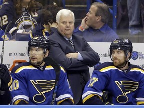 St. Louis Blues head coach Ken Hitchcock watches during the second period in Game 2 of the NHL hockey Stanley Cup Western Conference finals against the San Jose Sharks on May 17, 2016, in St. Louis. The Blues have signed coach Hitchcock to another one-year deal.
