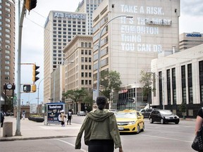 Final touches are put on the Wall of Encouragement in downtown Edmonton, Tuesday, June 21, 2016.  The mural is on Melcor's 100 St. Place building. Created and installed by local designer Clay Lowe, it reads, "Take a risk. It's the most Edmonton thing you can do."