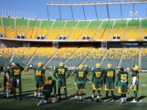 Members of the Edmonton Eskimos enjoying the  infield of what's now known as the Brick Field at Commonwealth Stadium. This week, the team announced it had signed a five-year deal with The Brick furniture store to sponsor the field, but not the stadium.